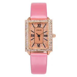 Women's rectangular quartz watch with orange sunray dial and crystal bezel pink strap