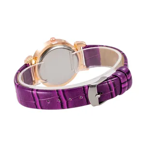 Detail of purple crocodile-pattern leather strap and rose gold case on a ladies watch