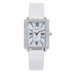 Women's quartz watch with rectangular crystal-encrusted case and white leather strap
