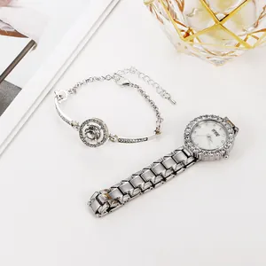 Detailed view of silver watch set with rhinestone bezel and matching diamond bracelet