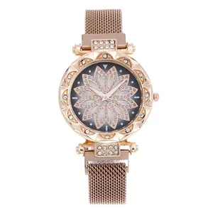 Close-up of rose gold mesh strap watch with sparkling floral diamond dial and bezel