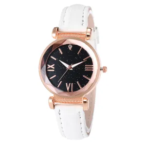 Close-up of women's quartz watch with starry black dial and white leather strap