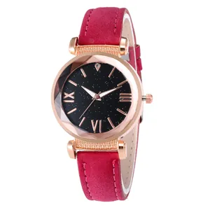 Detail of rose gold alloy watch case with starry dial and magenta suede strap