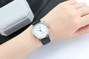 Close-up of Geneva men's quartz watch with silver case and Roman numeral white dial