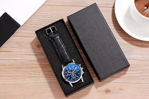 Detailed macro of a blue Geneva watch dial and black leather strap in an elegant gift box