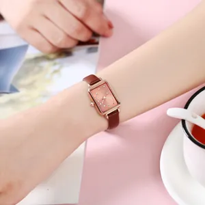 Elegant women's rectangular rose gold watch with brown leather strap and diamond dial