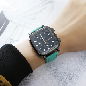 Detail of square quartz watch with teal leather strap and three functional sub-dials