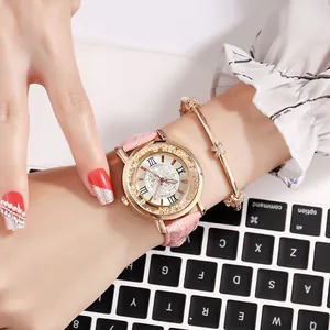 Close-up of rose gold watch with pink leather strap and matching fashion bracelet set