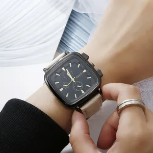 Close-up of elegant square quartz watch with black dial and beige textured leather strap