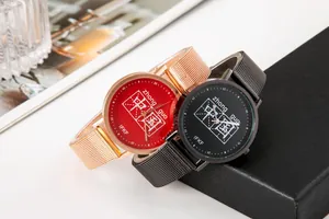 Dettaglio di orologi al quarzo con design a caratteri cinesi e cinturini in maglia metallica