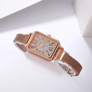 Detailed macro view of the sparkling rhinestone dial and elegant rose gold square case