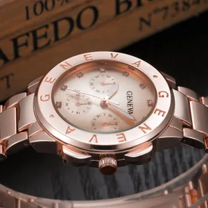 Rose gold Geneva quartz watch with diamond markers and metal strap on wooden box