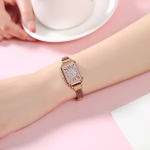 Elegant rose gold rectangular watch with starry rhinestone dial on a pink lifestyle background