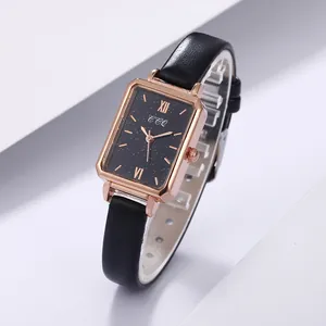 Macro view of rectangular rose gold case with starry black dial and leather strap