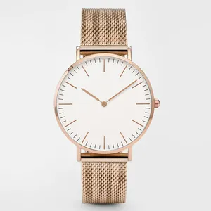 Detail of rose gold mesh band and minimalist white dial on quartz wristwatch