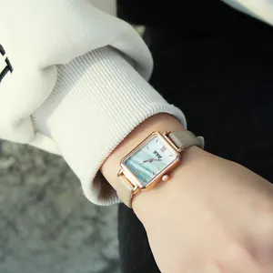 Elegant rectangular rose gold watch with blue mother-of-pearl dial and beige leather strap
