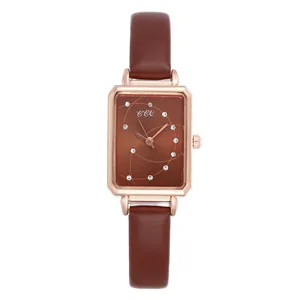 Detailed macro view of square brown watch face with gold case and leather strap
