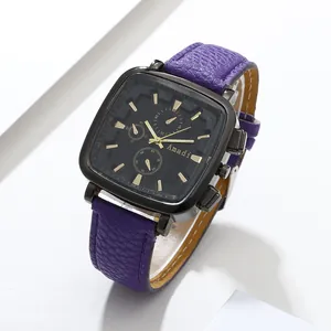 Detail of square black metal watch case with gold indices and purple leather strap
