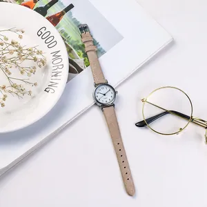 Elegant ladies watch with camel leather strap and white dial in a lifestyle setting