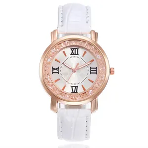 Detail of rose gold watch case with crystal bezel and white crocodile leather strap