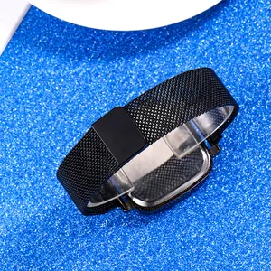 Detail of black Milanese stainless steel watch strap with magnetic closure on blue background