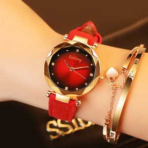 Close-up of a stylish red suede ladies watch set with a geometric gold bezel and heart bracelet