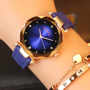 Close-up of a blue sunray dial watch with rose gold faceted case on a woman's wrist