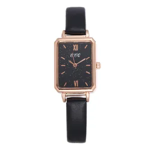Detail of the rectangular rose gold watch case with a black starry dial and leather strap