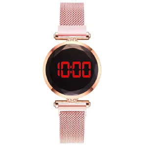 Detail of rose gold mesh band and faceted black LED dial on women digital watch