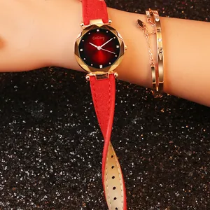 Detail of red suede strap and gold faceted case with luxury bracelet on wrist