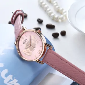 Close-up of pink leather watch with rose gold case and cute cat silhouette on the dial