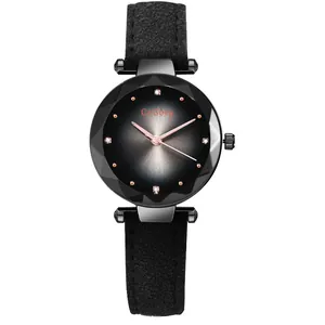 Detail of multi-faceted prism glass and black sunburst dial with rose gold hands