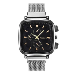 Close-up of the square black dial with gold markers and silver mesh metal watch band