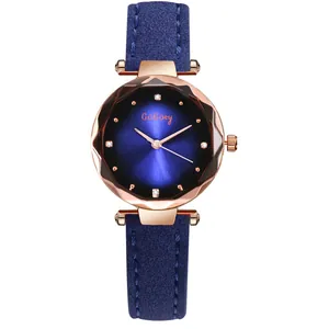Macro view of blue sunburst dial and faceted crystal on a rose gold women's watch