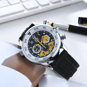 Detail view of men's chronograph watch with black silicone strap on office desk