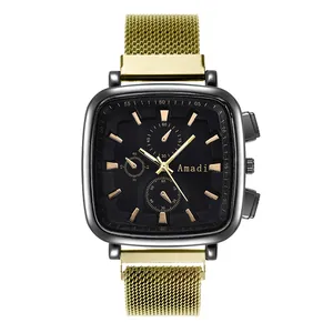 Detail of a square quartz watch with black dial and gold mesh steel strap