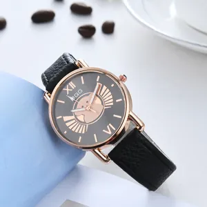 Macro detail of the rose gold dial featuring a cute cartoon motif and black leather strap