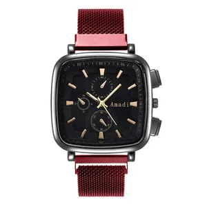 Detail of square quartz watch with black dial and burgundy mesh metal strap