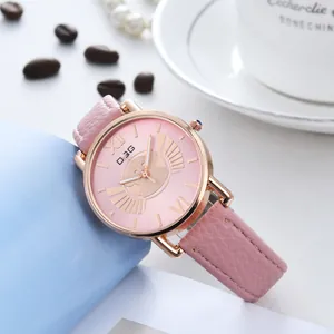 Close-up of pink leather quartz watch with rose gold case and cat dial on coffee table