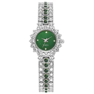 Detalle macro de un reloj de cuarzo para mujer con banda plateada y cristales verdes