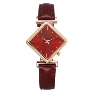 Détail du bracelet en cuir bordeaux et du cadran en forme de losange de la montre