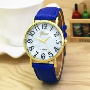 Detail view of gold quartz watch with blue leather strap and marble textured dial