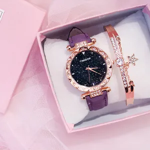 Close-up of women's starry sky watch and matching star bracelet in a pink gift box