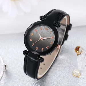 Detailed shot of woman watch with black patent leather strap and rose gold numerals