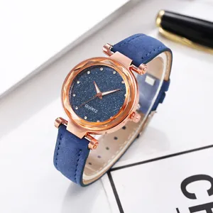 Close-up of sparkling starry dial and rose gold bezel on blue frosted leather strap