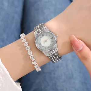 Detail of silver rhinestone watch with Roman numerals and heart-shaped crystal bracelet