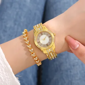 Close-up of luxury gold rhinestone watch and heart bracelet set on female wrist