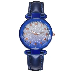 Detailed view of the rose gold Arabic numerals and blue glitter dial on the lady's watch