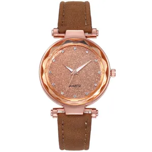 Detailed macro of a faceted glass watch face with rhinestone markers and quartz dial