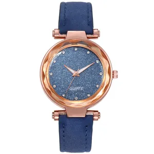 Detail of starry blue glitter dial with rhinestone markers and rose gold case on quartz watch